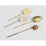 A Victorian 15ct gold garnet set stick pin, 6cm long, together with a pair of match 9ct gold stick