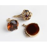 A 9ct gold stone set fob charm, comprising a circular faceted citrine coloured gemstone measuring