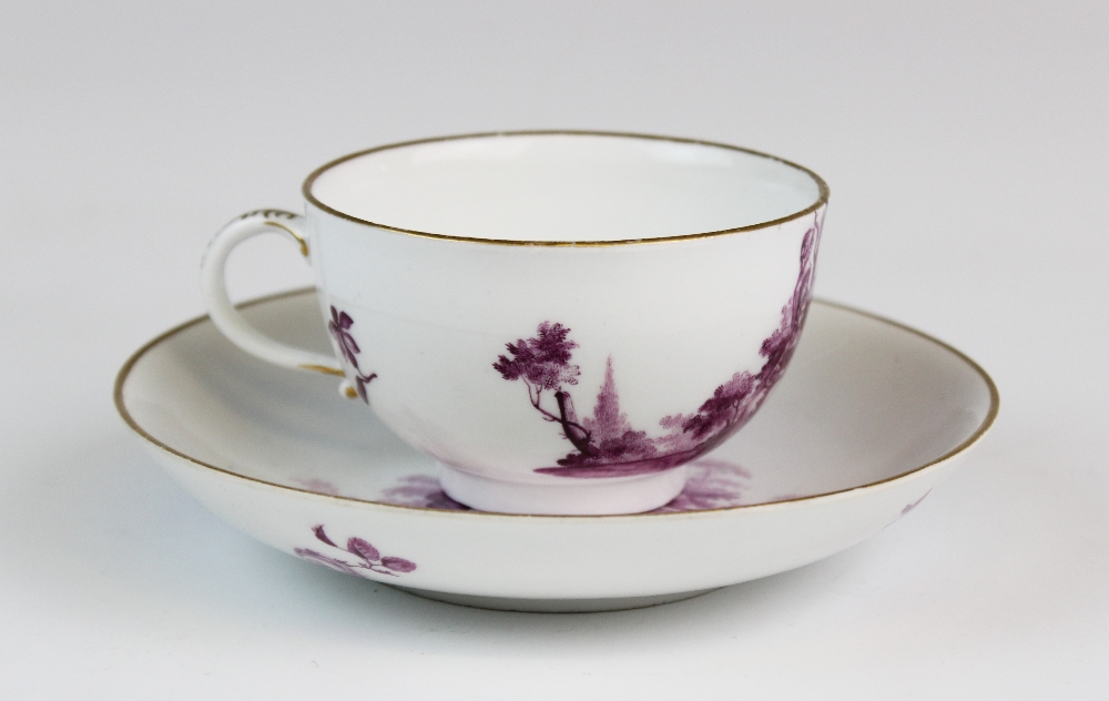 A Meissen porcelain tea cup and saucer circa 1775, finely painted with views of courting couples