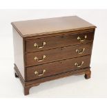 A George III style mahogany chest of drawers, the rectangular moulded top above three graduated