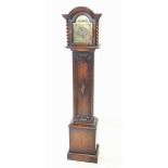A 1920's oak cased longcase clock, the arched hood with barley twist pilasters flanking the 19cm