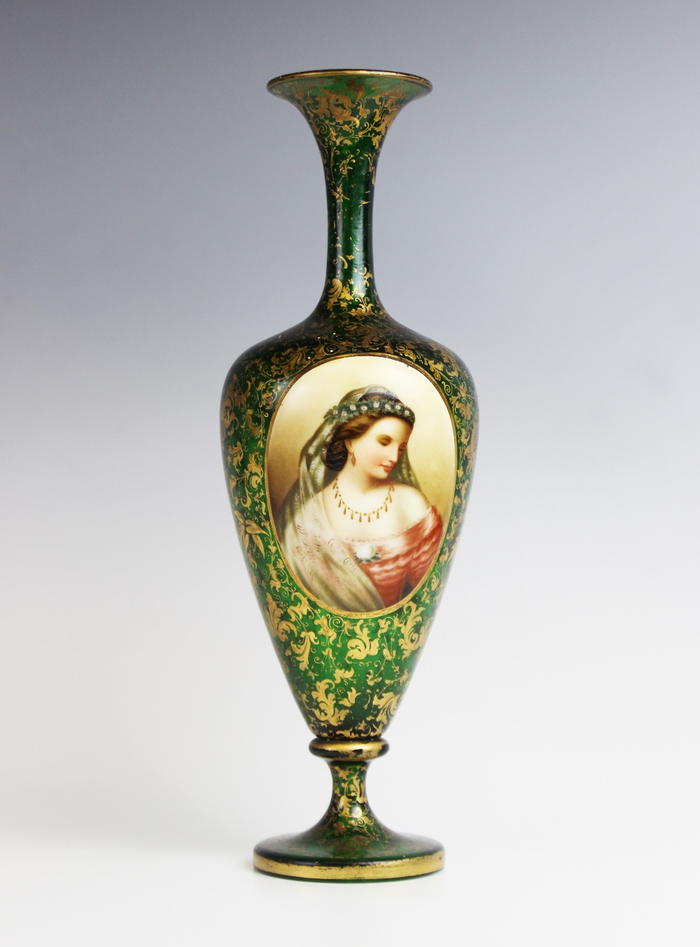 A Bohemian green glass portrait vase, 19th century, of slender inverted baluster form with