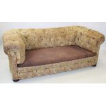 A Victorian foliate pattern Chesterfield type settee, with deep set button back and arms, raised