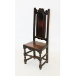 A late 17th /early 18th century and later oak hall chair, the arched panelled back rest above a