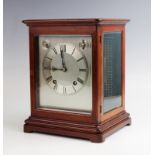 An early 20th century mahogany cased bracket clock, the 15cm silvered dial with subsidiary slow/fast