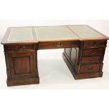 A 19th century style mahogany partners desk, the moulded inverted breakfront top inset with three
