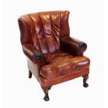 A George III style chestnut brown leather club armchair, late 20th century, the scalloped padded