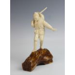 A fine Japanese Tokyo School okimono, Meiji period (1868-1912), modelled as a hunter walking on a