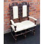 A 17th century style carved oak twin seat chair,