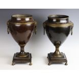 A pair of 19th century Adam style bronzed urns, of typical tapering form, with applied gilt metal