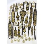 A collection of 19th century and later horse brasses, to include thirteen assorted leather straps