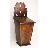 A 19th century oak candle box, of typical tapering form, with a shaped pierced back, 46cm high (at