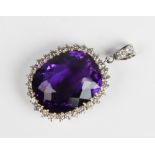 An amethyst and diamond pendant, the central cushion cut amethyst measuring approx. 28mm x 23mm x