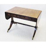 A George IV mahogany sofa table, the drop leaf top with rounded corners above two frieze drawers