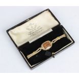 A lady's vintage 14ct gold Roamer wristwatch, the bronze toned tonneau shaped dial with Arabic