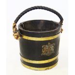 A 19th century style, coopered oak fire pail, applied with three brass bands and centred with a