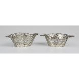 A pair of Edwardian Continental silver miniature twin handled baskets, each of oval form with shaped