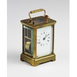 A late 19th century brass cased carriage clock, with a 6cm white enamelled dial applied with Roman