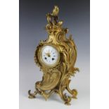 A late 19th century French gilt metal mantel clock, the 10cm white enamel dial with Arabic and Roman