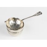 An Arts & Crafts style silver tea strainer and stand by Emile Viner, Sheffield 1935, the bowl with