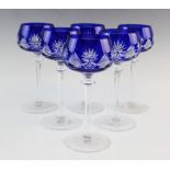 A set of six Bohemian style hock glasses, the flashed blue bowls cut with foliate and geometric