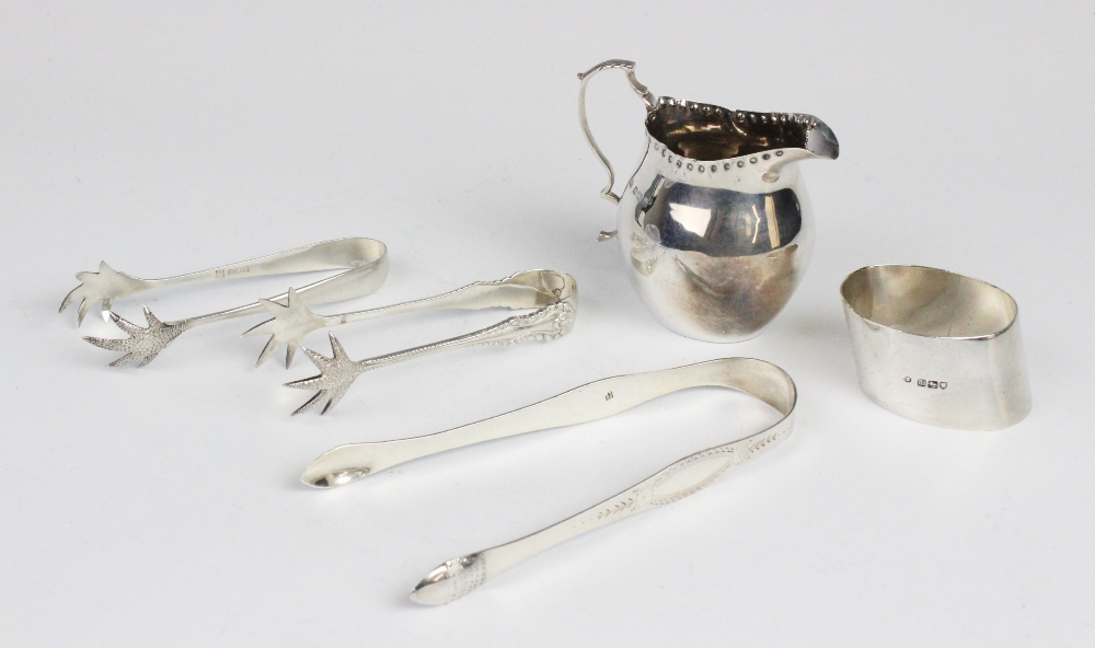 An Edwardian silver cream jug by George Unite, Birmingham 1904, of plain polished baluster form with