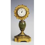 An early 20th century onyx and gilt metal mantel clock, the later 5cm white enamel dial with