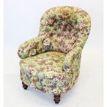 A Victorian button back tub chair, covered in floral pattern fabric, the concave padded back over