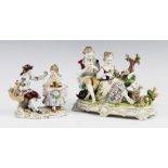 A Sitzendorf porcelain figural group, modelled as a courting couple picking flowers, picked out in