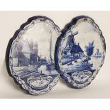 A pair of Delft hand painted blue and white wall plaques, 19th century, each of shaped oval form