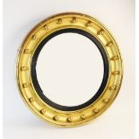 A Regency style giltwood convex circular wall mirror, 59cm diameter overall