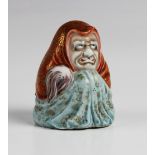 A Japanese Kutani porcelain model of Daruma, Meiji period (1868-1912), the figure of small