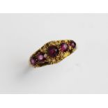 A Victorian amethyst and pearl 15ct gold ring, comprising five graduated mixed cut amethysts (