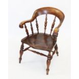 A 19th century elm and beech wood smokers bow elbow chair, the curved top rail extending to down
