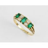 A Victorian/Edwardian emerald and diamond 18ct gold ring, the central rectangular step cut