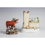 A Staffordshire pearlware bocage figural group, 19th century, modelled as a standing cow with a