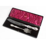 An Edwardian silver handled bread knife and fork by Walker & Hall, Sheffield, both with filled