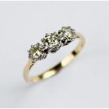 A diamond three stone ring, comprising a central round brilliant cut diamond (weighing approximately