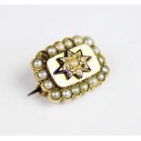 A 19th century diamond, pearl and enamel memorial brooch, the central starburst comprising a half