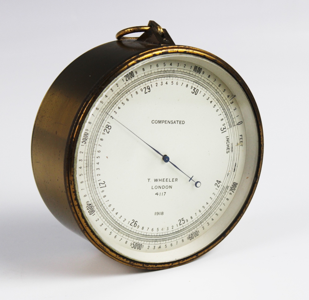 An early 20th century brass cased 'T Wheeler' compensated barometer, the drum shaped case