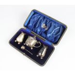 A cased three piece Edwardian silver condiment set by Atkin Brothers, Sheffield 1906, comprising two