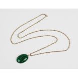 A malachite pendant on chain, the central polished oval malachite cabochon measuring 29mm x 20mm,