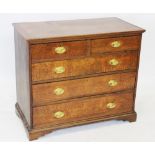 A George III oak and mahogany cross banded chest of drawers, the top inlaid with barber pole