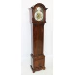 An early 20th century mahogany cased longcase clock, the arched hood with ring turned pilasters