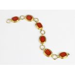 An Elizabeth Gage intaglio set 18ct gold bracelet, comprising six rectangular carnelian panels, each