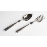 A matched George III silver serving fork and spoon, each with lion crest engraved to weighted