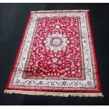 A red ground Kashmir silk carpet, with Shabaz medallion design, 230cm x 157cm