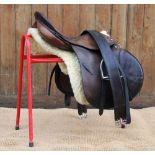 A Holberg 'Spring Seat' leather saddle numbered '3757', 8" wide, 18.5" seat, with associated