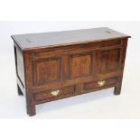 An early 18th century oak mule chest, the rectangular moulded top above three invert moulded