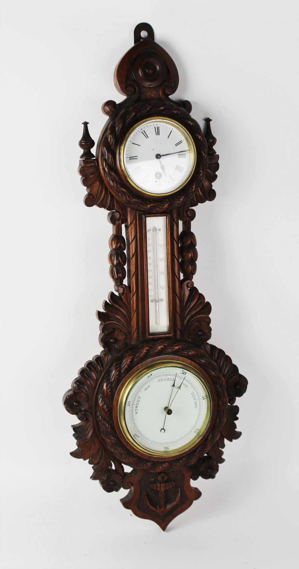 A Victorian carved oak nautical themed barometer and clock combined, the 9cm white enamel clock dial